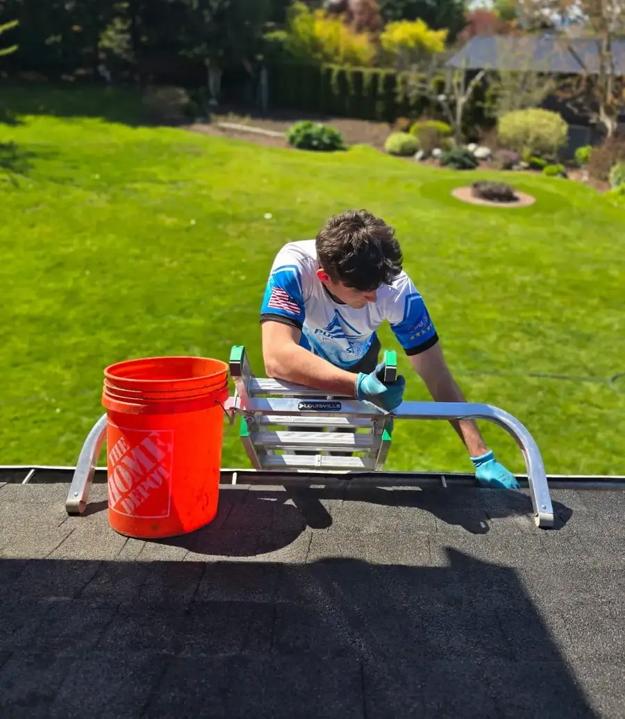 Technician on roof with equipment